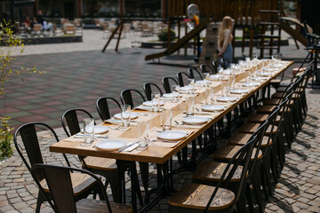 A large table is set near the children's playground on the street