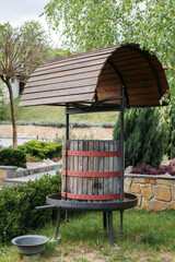 Fototapeta premium Wooden press for grapes landscape design in a cottage outside the city