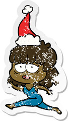 distressed sticker cartoon of a tired woman wearing santa hat