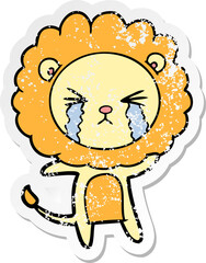 distressed sticker of a cartoon crying lion