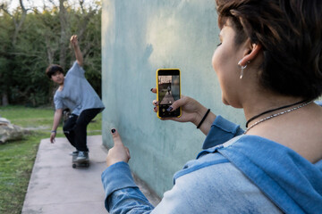 Sister's Thumbs Up Photo Captures Latin Teen Skater's Joyful Moment Outside. Brotherhood concept