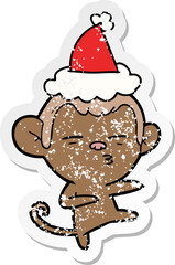 Obraz premium distressed sticker cartoon of a suspicious monkey wearing santa hat
