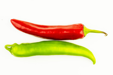 Two chili peppers, red and green, flat layout. Isolated on a white background hot peppers, peppers for lettuce. Baby food, veganism, dietary nutrition