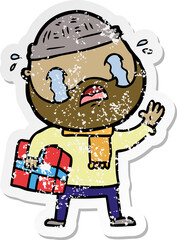 distressed sticker of a cartoon bearded man crying with christmas present