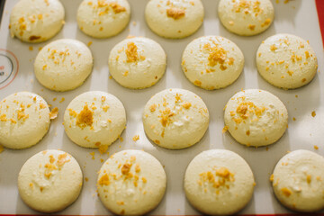 Freshly baked macaroons on a baking sheet.