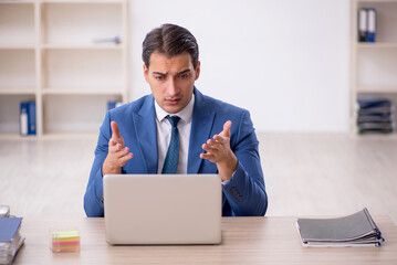 Young male employee working in the office