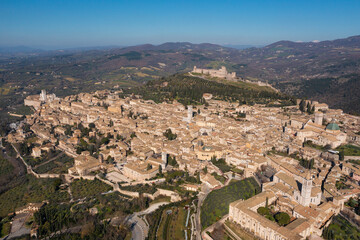 Fototapeta na wymiar extended frontal aerial view of the city of assisi umbria