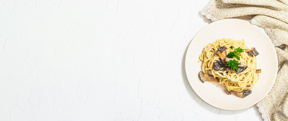 Spaghetti pasta with oyster mushrooms, creamy sauce and parsley. Healthy vegan food ready to eat