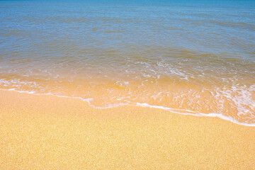 The coast of the Sea of Azov. Sea waves roll on the sandy shore. Seashell sandy beach.