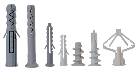 Plastic dowels of various types for fixing screws in the wall on an isolated background. Construction accessories used for repairs.