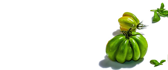 Green ribbed tomatoes isolated on white background. American or Florentine variety
