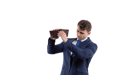 Handsome man in a suit turns over an empty wallet. Financial crisis and bankruptcy concept. Iwhite background copy space