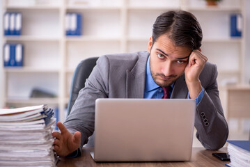 Young male employee working in the office