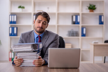 Young male employee working in the office