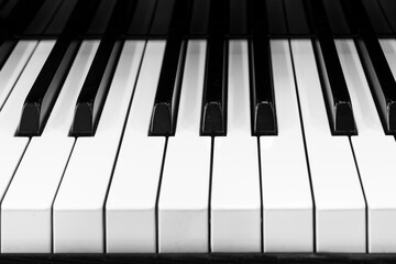 Close up of piano keyboard. Music instruments. Copy space. Black and White Piano Keys Taken From Above as a Flat Lay Image. Piano keys side view with shallow depth of field