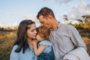 Fototapeta premium Young couple with cute two-years-old girl 