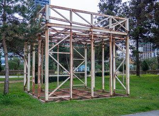 Fototapeta na wymiar Metal construction. Metal frame trade tent. Abandoned structure in the park.