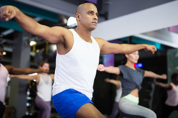 Fototapeta na wymiar Sporty man doing cardio exercises training with step platform at fitness center