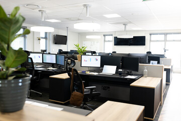 Open space office with desks, chairs and computers