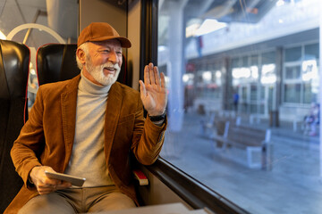 Man traveling in train and waving hand at station