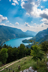 Fototapeta na wymiar Idyllic view of beautiful Lake of Molveno, province of Trento, Trentino Alto-Adige, Italy, in a cloudy and sunny summer day, surrounded by Dolomiti del Brenta mountains
