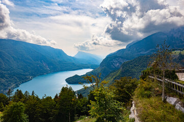 Fototapeta na wymiar Idyllic view of beautiful Lake of Molveno, province of Trento, Trentino Alto-Adige, Italy, in a cloudy and sunny summer day, surrounded by Dolomiti del Brenta mountains