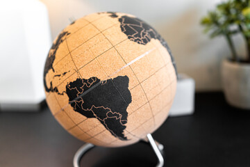 Modern or vintage retro brown globe world map with equator and South America continent as home...