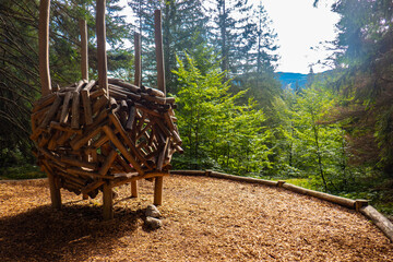 A wooden nest into the wood in Molveno park, Trentino Alto Adige, Italy