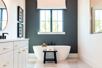 Bathtub in bathroom staging model home house or hotel with modern luxury white cabinets interior,...