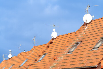 red roofs of family houses with antennas