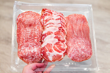 Salami slices with uncured sopressata, coppa and genoa salami with no nitrites on plastic tray with...