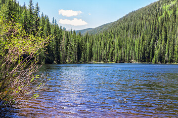 Beaver lake landscape from hiking trail in Beaver Creek ski resort near Avon, Colorado with water...