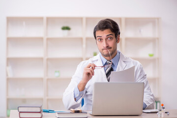 Young male doctor in telemedicine concept