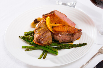 Top view of roasted duck breast with asparagus. High quality photo