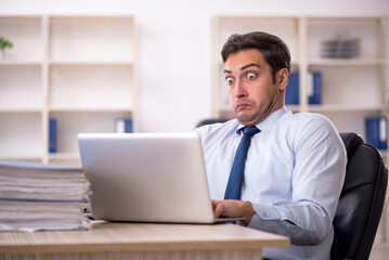 Fototapeta premium Young male employee working in the office