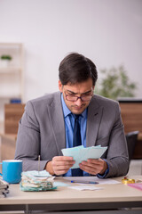 Young male accountant working in the office