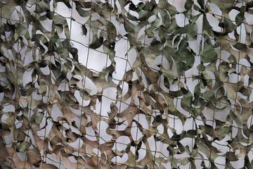 Close-up of a camouflage net for military use - background texture.