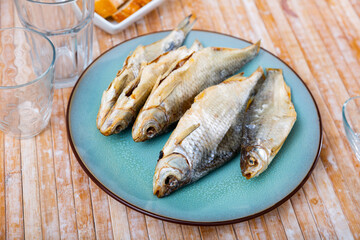 Dried salted fish roach, lying on a plate. High quality image