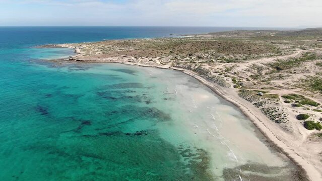 Aerial above turquoise water in Tecolote Beach in Baja Sur, Mexico