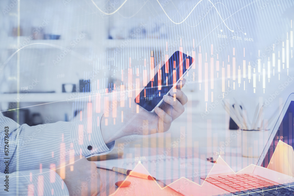 Poster double exposure of man's hands holding and using a digital device and forex graph drawing. financial