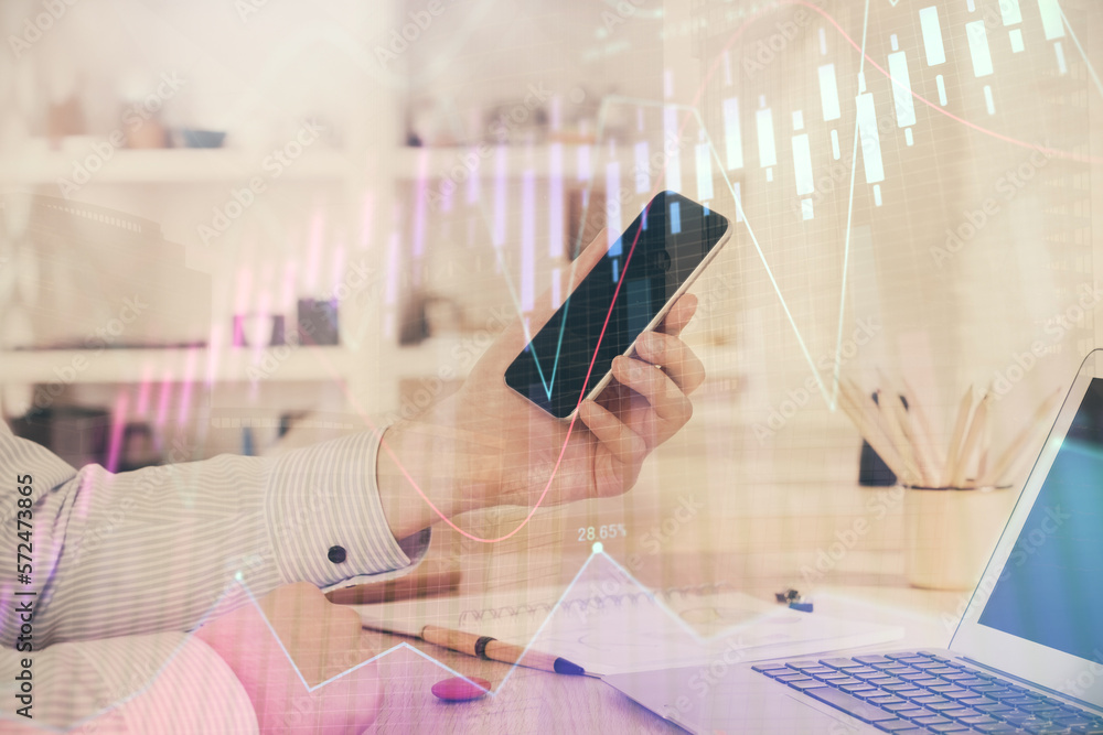 Poster double exposure of man's hands holding and using a digital device and forex graph drawing. financial