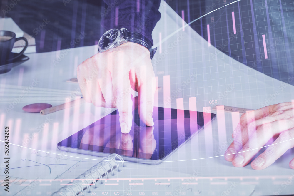Poster double exposure of man's hands holding and using a digital device and forex graph drawing. financial