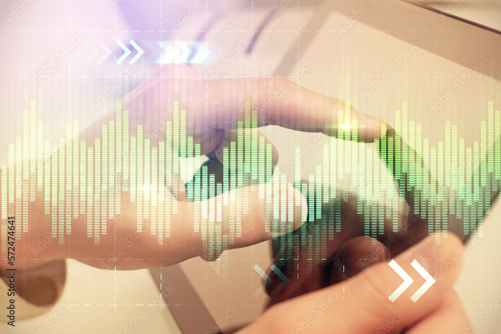Poster multi exposure of man's hands holding and using a phone and financial chart drawing. market analysis