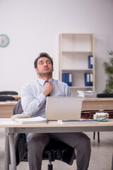 Young male employee working in the office