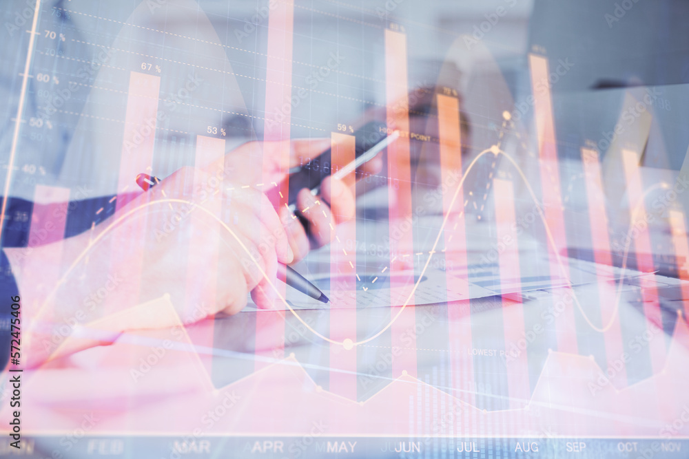 Poster double exposure of man's hands holding and using a phone and financial chart drawing. market analysi