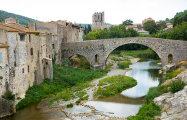 Fototapeta na wymiar Medieval vaulted arch bridge over Orbieu river in Lagrasse, France..