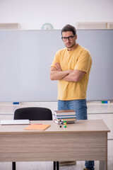 Young male student sitting in the classroom