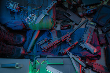 Tactical equipment and weapons.  Pistols, walkie-talkie, night vision, multitool, knives, silencer, etc.