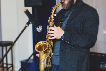 Concert view of saxophonist, a saxophone sax player with vocalist and musical band during jazz...