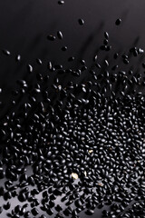 Black Bean flying explosion, black grain beans explode abstract cloud fly. Beautiful complete seed pea bean splash in air, food object design. Black background high speed shutter freeze motion